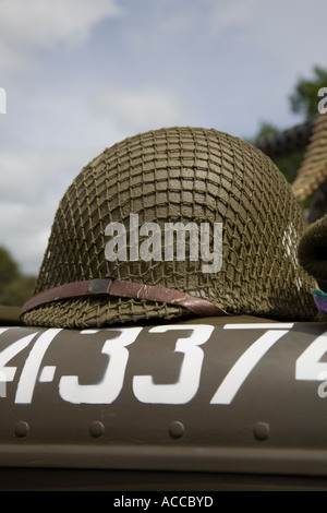 American Second World War US military infantry troop helmet on the hood of a jeep Stock Photo