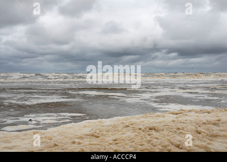 Foam used to tackle an oil spillage on the beach at Formby near Southport Stock Photo