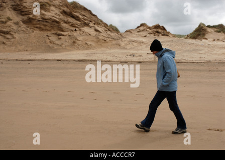 Walking along the beach at Fornby in Lancashire Stock Photo