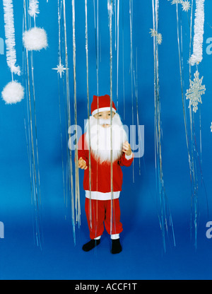 A boy dressed as Santa Claus. Stock Photo