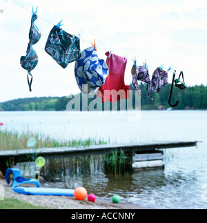 Swimming costumes drying on a clothes line. Stock Photo
