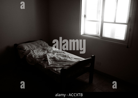Single bed unmade in  white room Stock Photo
