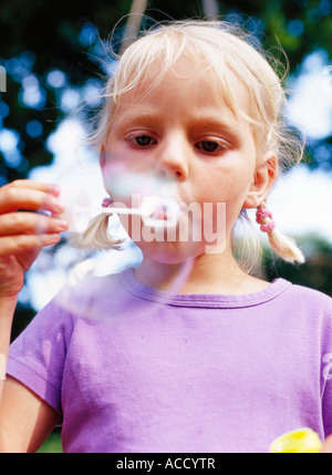 girl playing with soap bubbles in a beautiful garden Stock Photo - Alamy