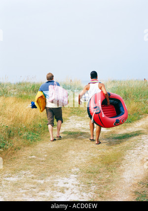 Two men in a rubber dinghy silhouetted against water Stock Photo - Alamy