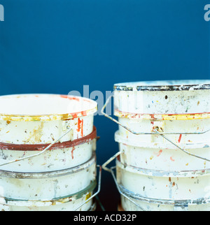 Empty paint buckets on a blue background. Stock Photo