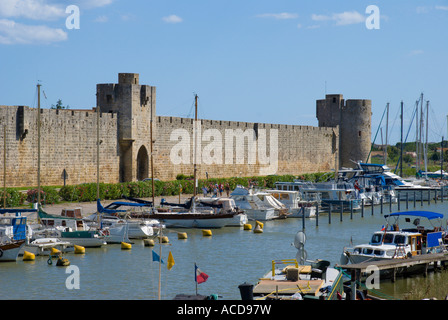 France Aigues Mortes Camargue Provence Bouches du Rhone castle walls and fortifications with canal and marina Stock Photo