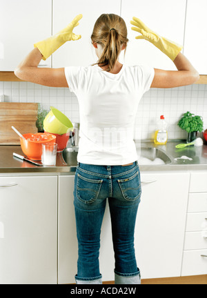 A woman doing the dishes rear view. Stock Photo