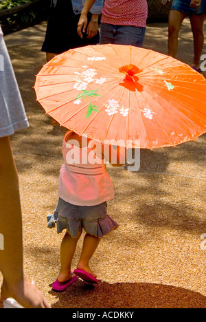 Little Girl with Orange Umbrella Stock Photo
