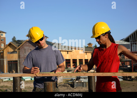 Construction workers measure building materials Stock Photo