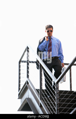 Businessman walking down stairs Stock Photo