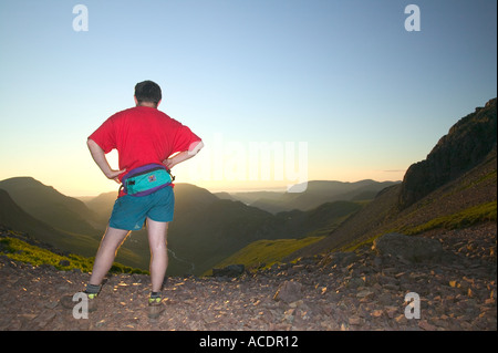 Walker on Windy Gap Great Gable at sunset looking down the Ennerdale Valley Stock Photo