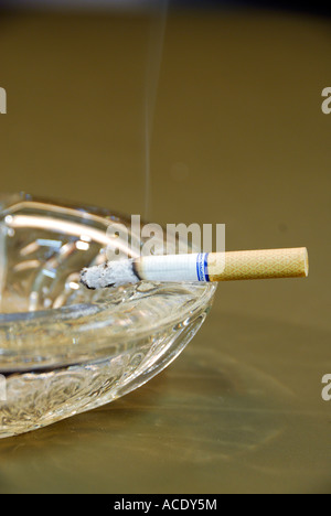 Cigarette Burning In Ash Tray Stock Photo