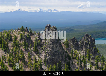 Paulina Peak lava columns and lake at Newberry Crater caldera and snow capped Three Sisters Mount Bachelor Cascade mountains near Bend Oregon USA Stock Photo