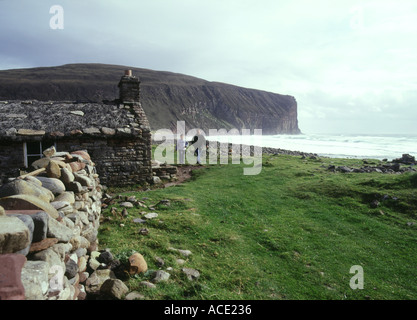 dh Rackwick HOY ORKNEY Father and son by bothy cottage and Craig gate walking strolling bay people remote