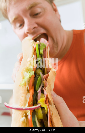 Man eating a big hoagie sandwich Stock Photo