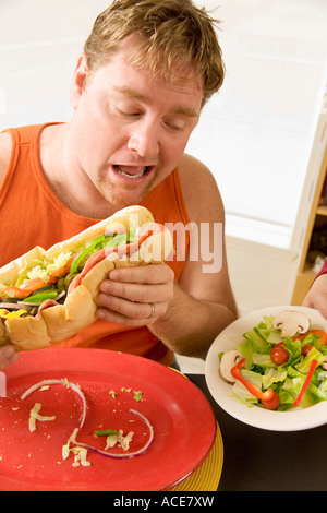 Man eating a big hoagie sandwich Stock Photo