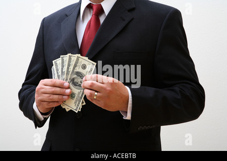Businessman holding 100 dollar bills Stock Photo
