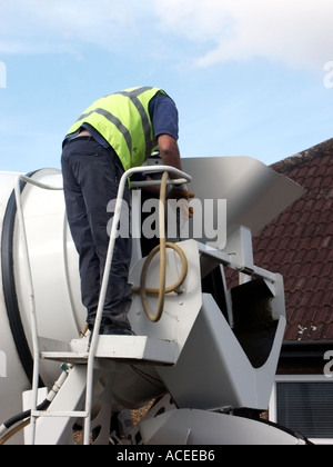 Ready mixed concrete delivery driver moving chute direction whilst