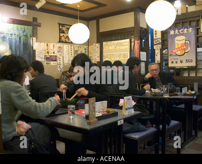 Interior view of a small neighborhood restaurant visited by ordinary people enjoying an evening of dining on local favorites Stock Photo