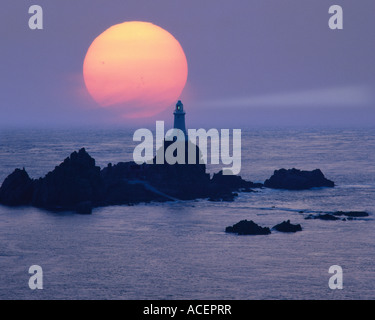 GB - JERSEY: Sunset at La Corbiere Lighthouse Stock Photo