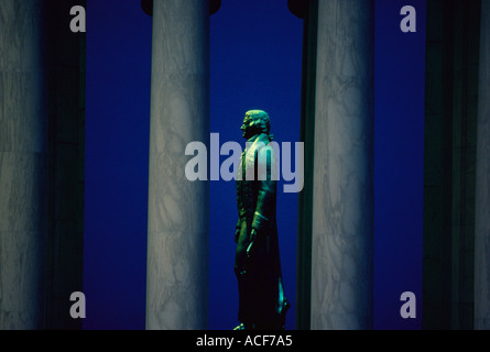 Bronze statue of Thomas Jefferson seen in profile between the columns of the Jefferson Memorial Washington DC Stock Photo