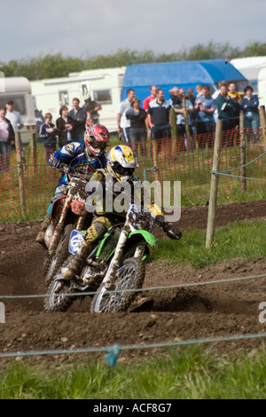 Group of Motocross riders cornering during race Stock Photo