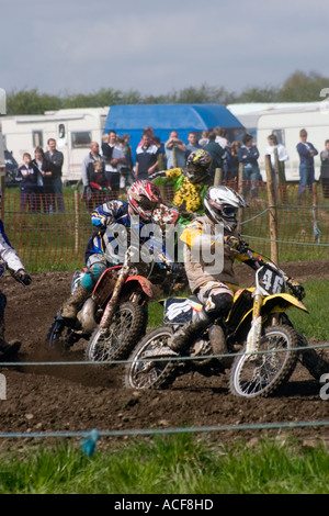 Group of Motocross riders cornering during race Stock Photo