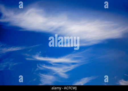 White Cirrus clouds in a bright blue polarised sky Stock Photo