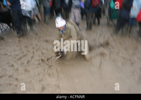 Mud monsters, Two excited young men wrestling in the Mud at the Glastonbury Festival 2007. Stock Photo