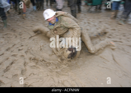 Mud monsters, Two excited young men wrestling in the Mud at the Glastonbury Festival 2007. Stock Photo