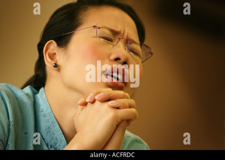 Woman praying Stock Photo
