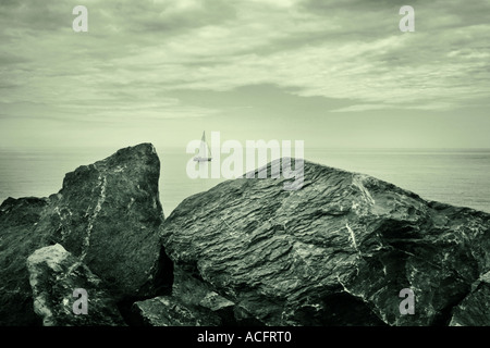 sailing between rocks Stock Photo - Alamy