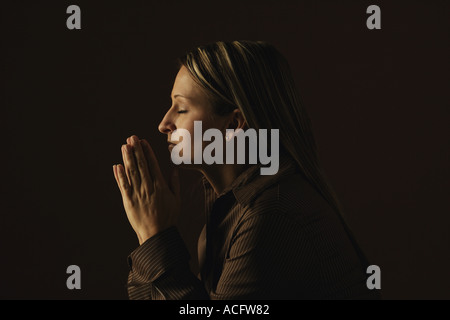 Woman praying Stock Photo
