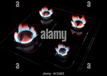 Natural gas flames on kitchen cooker hob Stock Photo