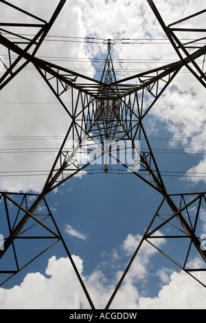 Electricity pylon abstract against blue sky and clouds Stock Photo