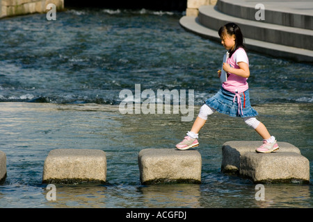 Young Korean Girl Crossing Cheonggyecheon or Cheonggye Stream Seoul South Korea Stock Photo
