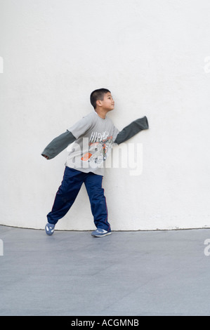 Boy plays hide and seek on front off MACBA Contemporary Art Museum of Barcelona Barcelona Catalunya Spain Europe Stock Photo