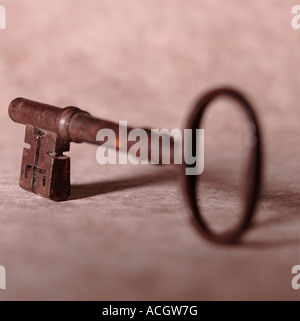 An old style church wooden door iron steel black locking key on brown background Stock Photo