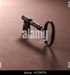 An old style church wooden door iron steel black locking key on brown background Stock Photo