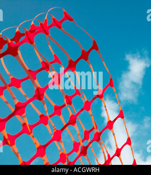 A red protective contemporary mesh with bright blue sky in the background Stock Photo