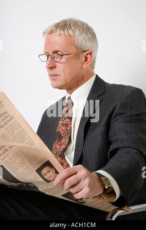 Businessman reading newspaper Stock Photo