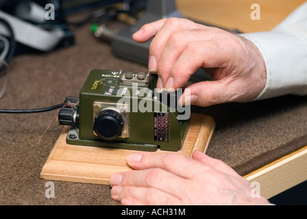Blind man indulging his hobby for amateur radio and using morse code device, London, UK. Stock Photo