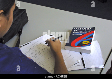 Mature female student, Oxford Dictionary in ESOL class at FE London college Stock Photo