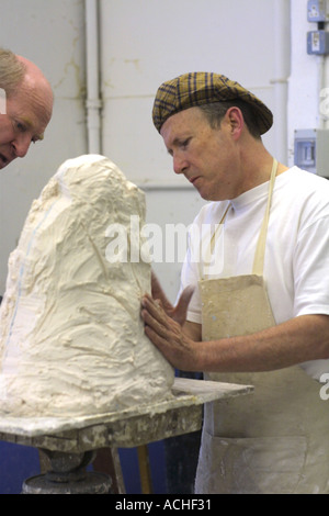mature student in Clay sculpture class at London college Stock Photo