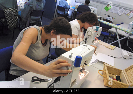 Student using sewing machine in sowing and making clothes class at college in London bOrough of  Camden Stock Photo