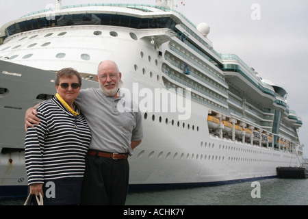 Senior couple ready for another cruise in front of a cruise ship. Stock Photo