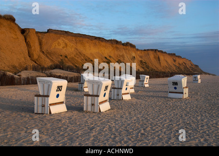 Beach chairs in front at cliff Rotes Kliff near Kampen at dusk, Sylt, Schleswig Holstein, Germany Stock Photo