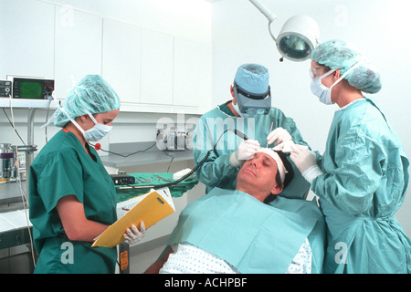 Medical specialist in operating room doing hair transplant Stock