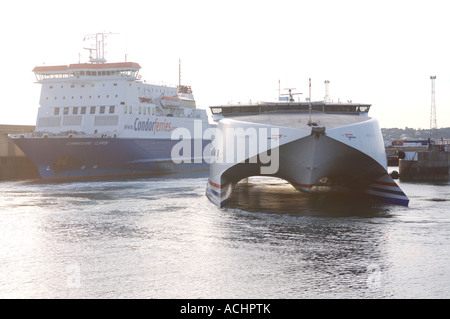 Ships coming into and docking in Elizabeth Harbour jersey channel islands Stock Photo