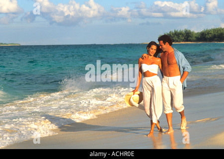Romantic couple walking on beach Stock Photo